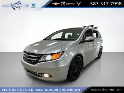 Our used family-friendly 2014 Honda Odyssey Touring is shown in stunning Alabaster Silver Metallic....