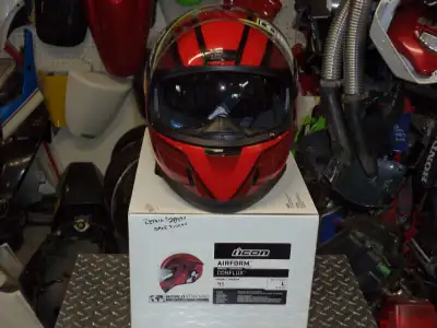 sonic cycle has a brand new icon airform red large helmet with built in sun glasses dot aproved . re...
