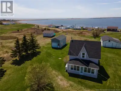 ** Charming Coastal Property with Cottage and Garage** Discover this beautiful older home, ideally l...