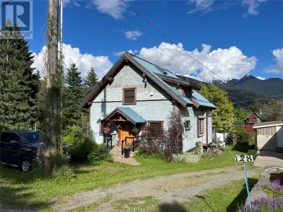 On a large and flat landscaped corner lot on a quiet street in Upper Kaslo stands this architectural...