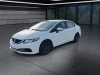 The 2014 Honda Civic Sedan LX, in a pristine white finish and equipped with a smooth front-wheel-dri... (image 3)