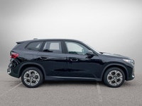 The 2025 BMW X1 xDrive28i arrives as a striking black Sport Utility vehicle, seamlessly blending ath... (image 3)