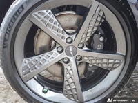 * 21-inch sport alloy wheels, dark-tinted radiator grille, unique front/rear bumpers, and large exha... (image 8)