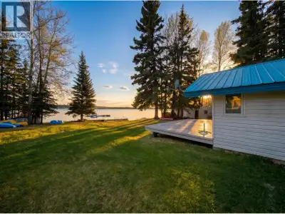 A Rare Dual-Cabin Lakeside Retreat on a Sun-Drenched Level Lot. Discover the ultimate family compoun...