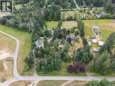 Rare 5.14-acre property in the desirable town of Qualicum Beach offering space, versatility, privacy...