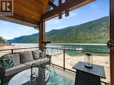 Experience lakeside living at its finest in this stunning top-floor corner unit at the sought after...