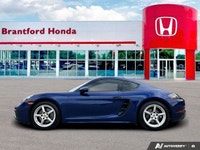 Feel the exhilaration of the open road with this stunning 2020 Porsche 718 Cayman in vibrant Gentian... (image 1)