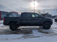 The 2026 Ram 1500 RHO Crew Cab in Diamond Black Crystal Pearl delivers bold styling and high-perform... (image 7)