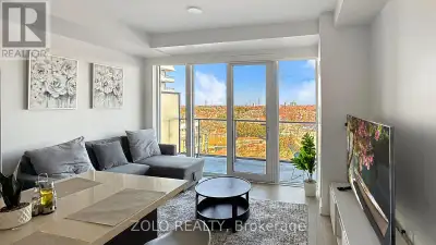 Modern one-bedroom-plus-den, two-bathroom suite with a bright, open-concept living and dining area,...