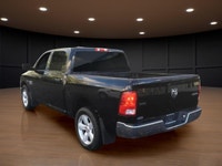 The 2022 Ram 1500 Classic SLT 4x4 Crew Cab in striking black is the perfect combination of power and... (image 7)