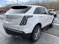 The 2026 Cadillac XT5 Sport AWD, finished in Crystal White Tricoat with a rich Kona Brown interior w... (image 8)