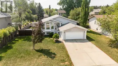 What a great location! This fantastic family home sits on a quiet tree-lined street on a 77'x157' lo...