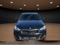 The 2022 BMW X2 xDrive28i Sports Activity Coupe in a sophisticated black finish and equipped with BM... (image 2)