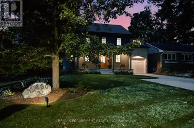 A thoughtfully designed family home in Aldershot South, set against a backdrop of mature trees with...