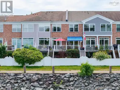 Brick townhouse just 40 feet from the water in Bedford with no condo fees! This three-level home fea...