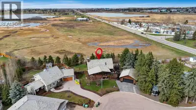 Welcome to a truly rare lifestyle property at 2 Wheatland Green in Strathmore—where timeless log cra...