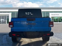 Conquer every landscape in this 2023 Jeep Gladiator Rubicon, gleaming in Hydro Blue Pearl. With only... (image 3)