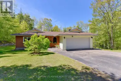 On a quiet country road, nestled in the trees you will find this lovely, spacious bungalow on approx...