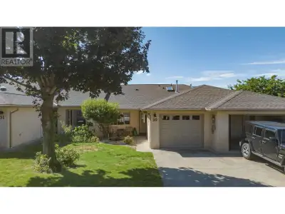 Enjoy the stunning view over the swimming pool and the valley beyond from the covered deck. This thr...