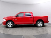 Introducing the Ram 1500 Classic Express 4x4 Crew Cab, a striking red truck that blends power and ca... (image 1)