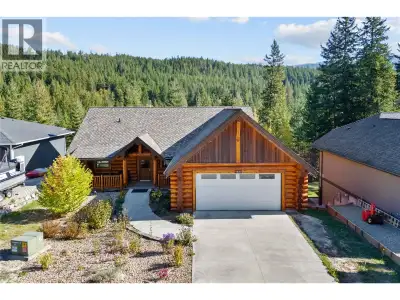 Stunning handcrafted red cedar log estate, privately situated on a quiet cul-de-sac in the sought-af...