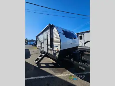 This travel trailer features 1 slide, secure stance step, outside fridge, front kitchen with portabl...