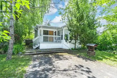 WHERE EVERY DAY FEELS LIKE A MINI VACATION IN THIS TURN-KEY ESCAPE BACKING ONTO A POND & SURROUNDED...