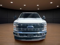 The 2023 Ford Super Duty F-250 SRW XLT in striking white comes equipped with a robust 4x4 drivetrain... (image 2)