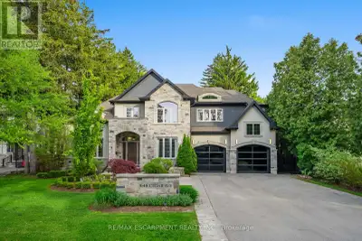 A custom home of over 6,000 finished sq ft, set on half an acre & framed on every side by evergreens...