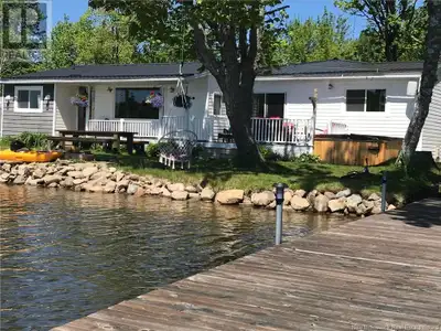 Escape to the peace and beauty of Davidson Lake with this beautifully expanded 5-bedroom, 2-bathroom...