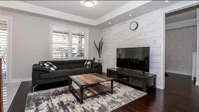Skip the high-rise elevators. This main-level, end-unit townhome functions like a semi-detached hous...