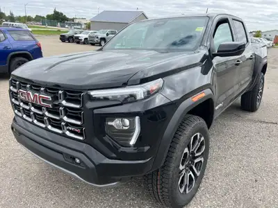 The 2025 GMC Canyon AT4 Crew Cab Short Box 4-Wheel Drive is a robust, all-terrain black beauty desig...