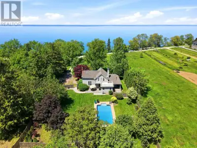 WATERFRONT LIVING ON OVER AN ACRE OF LAKE ONTARIO SHORELINE!Welcome to 4698 Sandy Cove, a rare water...
