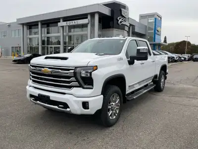 The 2026 Chevrolet Silverado 2500HD High Country in pristine white with its powerful 44 drivetrain a...