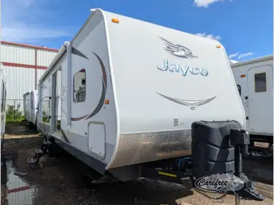 The Jay Flight 29RKS travel trailer by Jayco features a single slide and a rear kitchen area. Steppi...