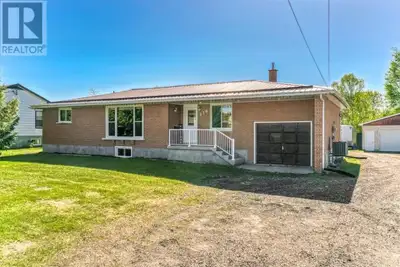 Welcome to this impressive all-brick bungalow situated on a rare double lot, offering incredible spa...