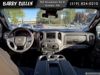 The 2026 Chevrolet Silverado 2500HD Work Truck in pristine white and equipped with a rugged 4x4 driv... (image 6)