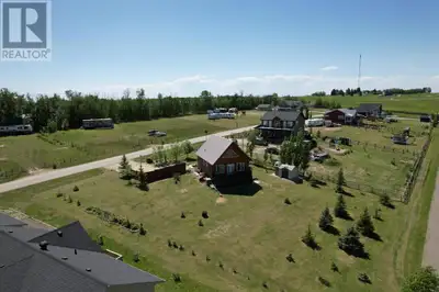 High above the shores of Gull Lake in Parkland Beach, Alberta, this charming 939 square foot pine wo...