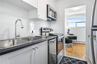 Fully renovated spacious suite features kitchen with modern features and finishes including laminate... (image 8)