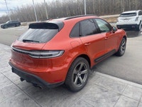 The 2023 Porsche Macan AWD, finished in eye-catching Papaya Metallic, brings true sports car DNA int... (image 5)