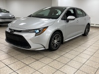 Dawn paints the streets in quiet silver as the 2021 Toyota Corolla L slips from the curb, its LED be... (image 1)
