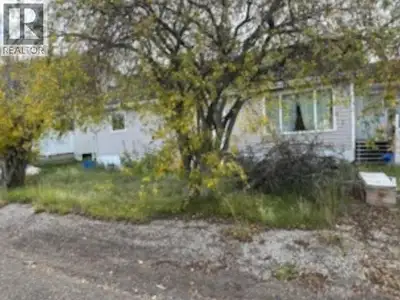 3-bed, 1-bath bungalow with over 1100 sq. ft. of living space, featuring a wood stove to offset heat...