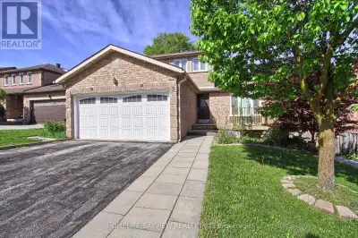 Nestled on a peaceful court, Enjoy hardwood floors, 18" marble tile foyer, crown moulding, wainscoti...