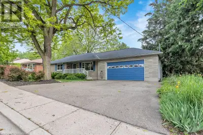 Welcome to this brick bungalow on beautifully professionally landscaped lot with attached 1 and 1/2...