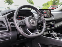 The 2023 Nissan Rogue AWD S in a sleek black hue complements its AWD capabilities, delivering a smoo... (image 7)