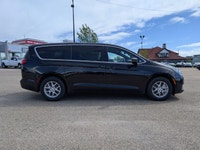 The 2026 Chrysler Grand Caravan SXT in Diamond Black Crystal Pearl with a Black interior offers a bl... (image 6)