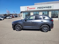 Command every journey with confidence and sophistication in this Machine Grey Metallic 2021 Mazda CX... (image 1)
