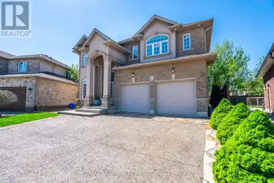 Your dream home awaits at this custom-built 2,655 square foot masterpiece nestled on a generous pie...