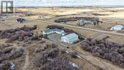 Set on 4.15 acres of private, tree filled land just minutes from Okotoks and Calgary, this fully fin...