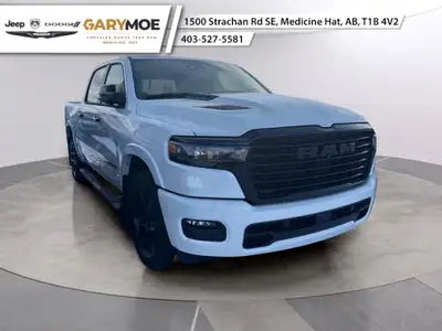 The 2025 Ram 1500 Laramie, dressed in a pristine white, features a robust 4x4 drivetrain that master...